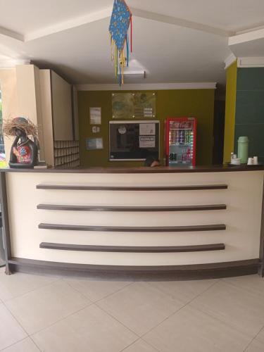 a kitchen with a counter top in a restaurant at Hotel Absolar in Alagoinhas