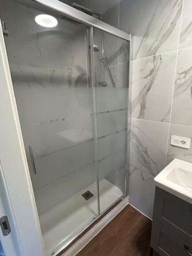 a shower with a glass door in a bathroom at Palazzo Modafi in Bagni di Lucca