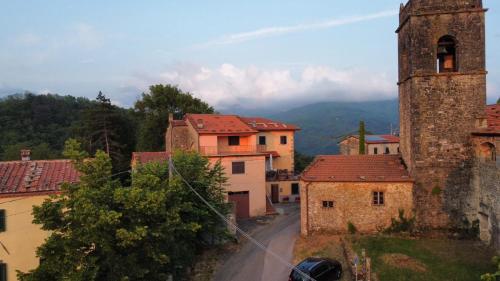 a view of a town with a tower and buildings at Palazzo Modafi in Bagni di Lucca