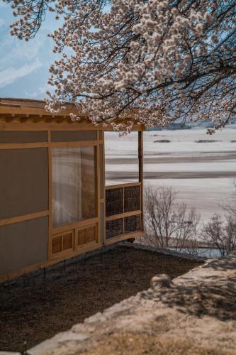 a house with a window and a tree at Dera Lamsa Resort Shigar in Shigar