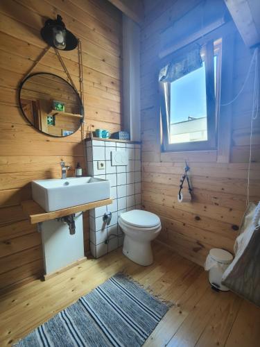 a bathroom with a white toilet and a sink at O Gato do Mar in Viana do Castelo