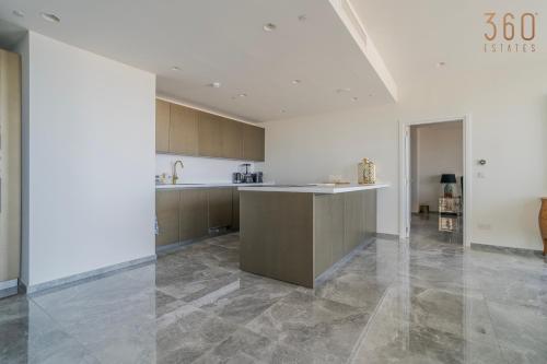 a large kitchen with a counter in a room at Official Apartments of Mercury Towers by MyMercury in St. Julianʼs