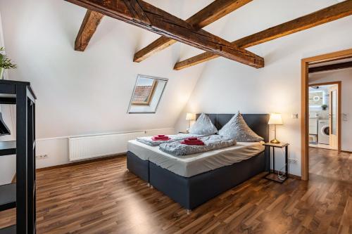 a bedroom with a bed in a room with wooden floors at Ferienhaus Oberlausitz mit 160qm in Cunewalde