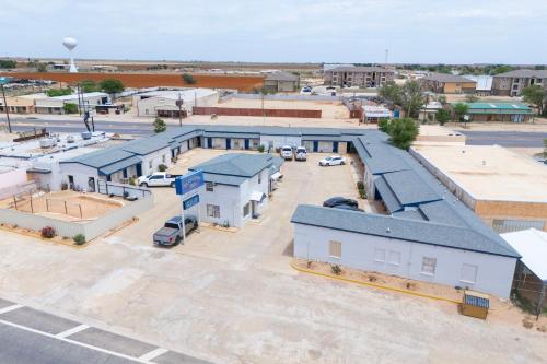 an aerial view of a parking lot with buildings at Economy Inn By OYO, Lamesa TX in Lamesa