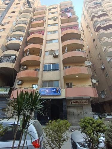 a tall building with a car parked in front of it at home in the pyramids in Cairo
