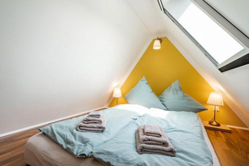 a bedroom with a bed with towels on it at Ferienhaus Oberlausitz mit 160qm in Cunewalde
