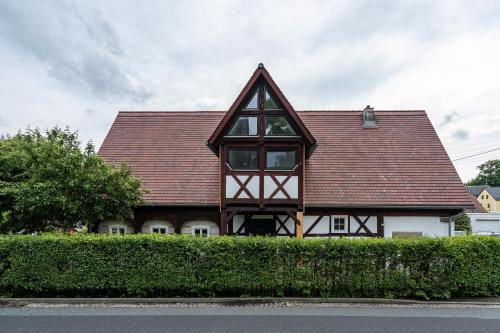 a brown and white house with a roof at Ferienhaus Oberlausitz mit 160qm in Cunewalde