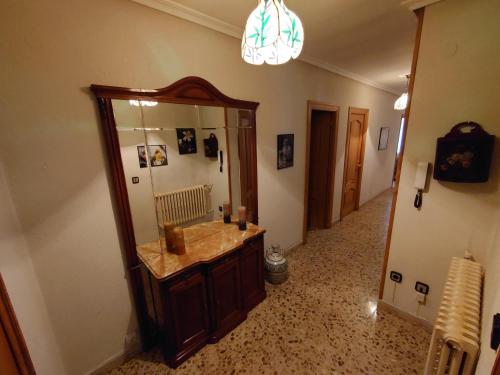 a bathroom with a sink and a large mirror at casa 1, 2 o 3 habitaciones - HOSTAL CAMELOT in Fabero