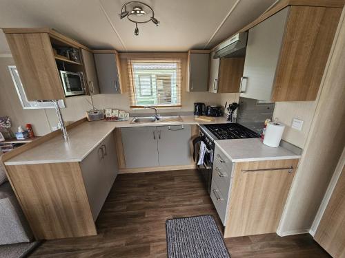 a small kitchen with a sink and a stove at Punchbowl Caravan Park in Penrith