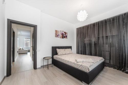 Un dormitorio con una cama y una ventana grande. en 8 Vorontsove Lane Apartment, en Odessa