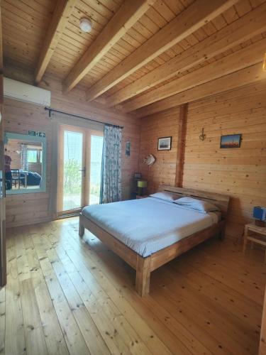 a bedroom with a bed in a wooden room at O Gato do Mar in Viana do Castelo
