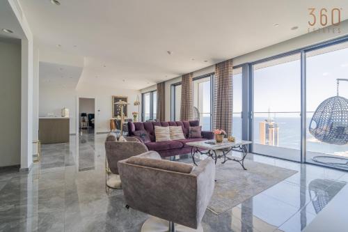 a living room with a couch and a table at Official Apartments of Mercury Towers by MyMercury in St. Julianʼs