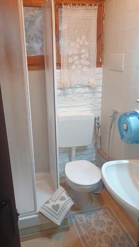 a small bathroom with a toilet and a sink at Benjamin Room in Olbia