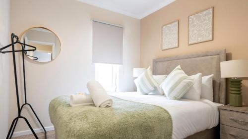 a bedroom with a large bed with a mirror at Forbes House in Glasgow