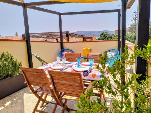 a table and chairs on a patio with a view at Appartamento La Terrazza - Località Cala Gavetta in La Maddalena