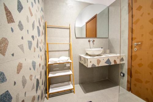 a bathroom with a sink and a mirror at Sia Villa in Lardos