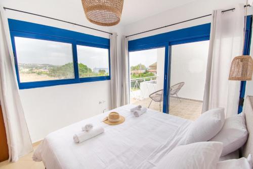 a bedroom with a bed and a large window at Sia Villa in Lardos