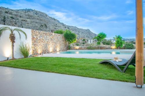 a villa with a swimming pool and a garden at Sia Villa in Lardos