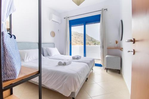 a bedroom with a bed and a window at Sia Villa in Lardos