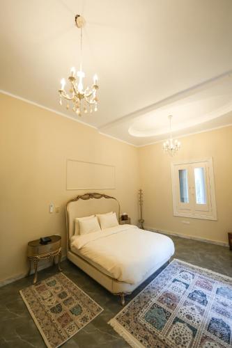 a bedroom with a bed and a chandelier at The H Zamalek Suites in Cairo