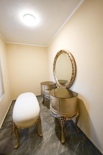 a dressing room with a mirror and a chair at The H Zamalek Suites in Cairo