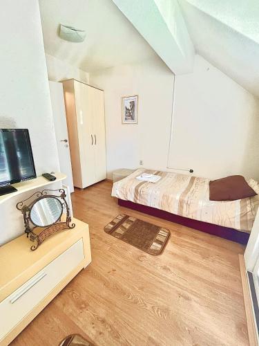 a bedroom with a bed and a desk with a tv at A&M Apartments in Ohrid