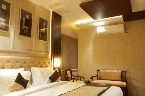 a hotel room with a bed and a chair at Suramya Homestay Near Shymala Hills in Bhopal