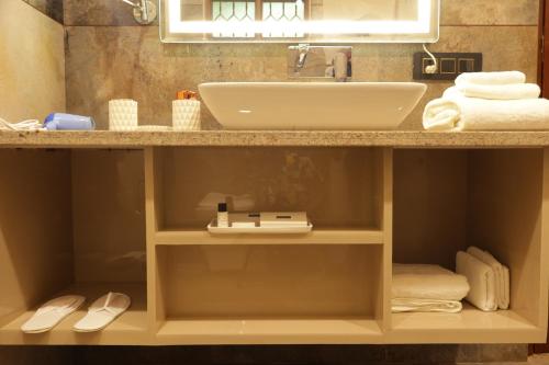 a bathroom with a sink and a counter with towels at Suramya Homestay Near Shymala Hills in Bhopal