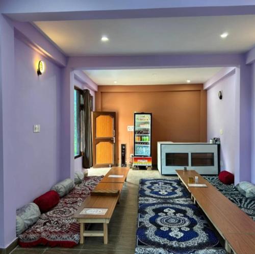 a living room with couches and a fireplace at Majestic House and Bonkers on the go Café in Kalgha