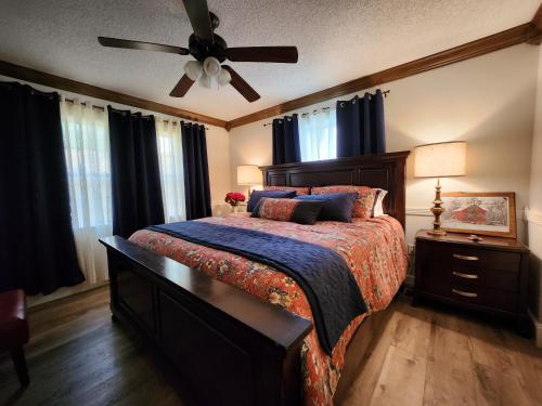 a bedroom with a bed and a ceiling fan at Lake Greenwood Lodge Main House and guesthouse in Isle of Pines