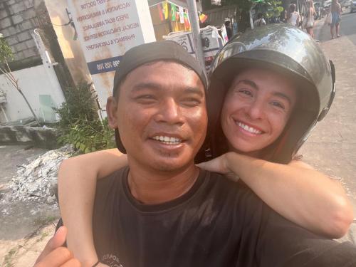 a man and a woman with a helmet on their head at ekasboardriders surf&stay in Ekas