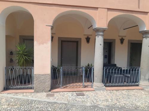 a building with three arches and a fence at La Corte Dei Cappuccini in Bergamo