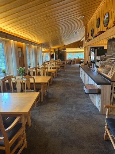 a dining room with wooden tables and chairs at Toftemo Turiststasjon in Dovre