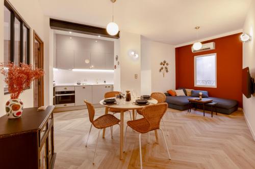 un salon avec une table, des chaises et un canapé dans l'établissement L'Instant Nîmois, à Nîmes