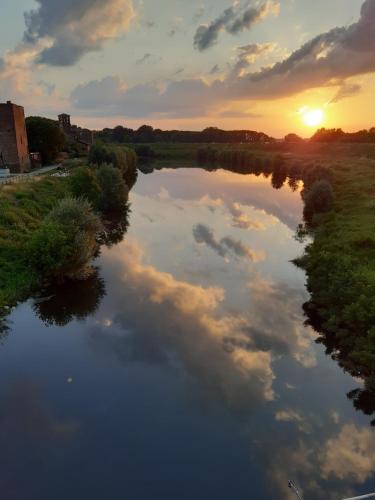 a river at sunset with clouds in the water at Museo Grillo Camere d'Arte, dormire nel Museo in Arena Po