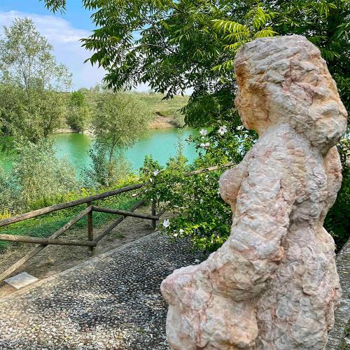 a statue of a bear standing next to a river at Museo Grillo Camere d'Arte, dormire nel Museo in Arena Po