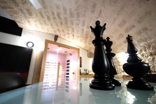 two chess pieces sitting on top of a glass table at Dimora San Rocco in Molfetta