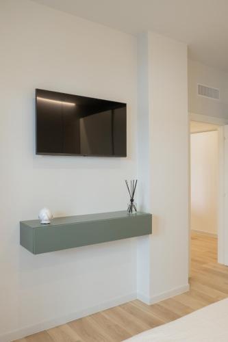 a television on a wall in a room at Lolla's home in Monopoli