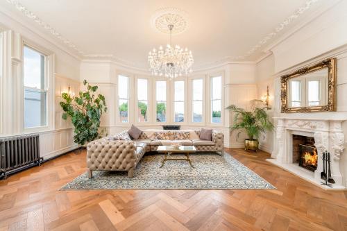 a living room with a couch and a fireplace at Luxury Villa - City Centre - Sleeps 13 in Nottingham