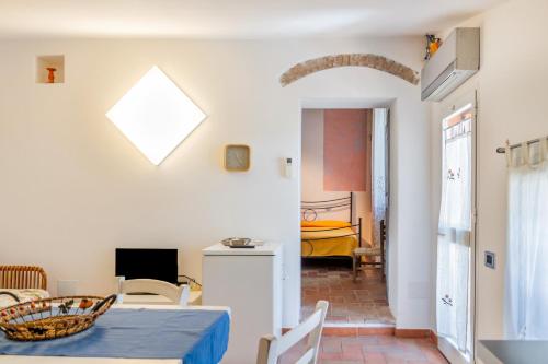 a living room with a table and a dining room at Agriturismo Giardini Di Varrone in Bagno Roselle