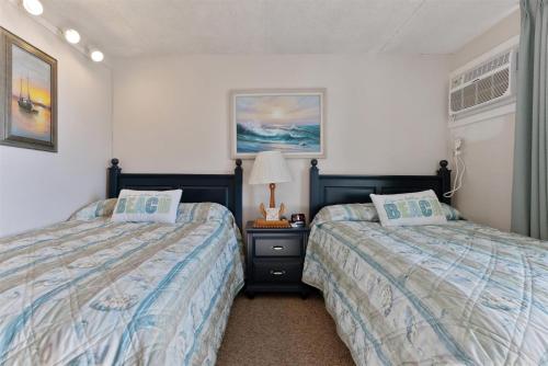 a bedroom with two beds next to each other at 225 E Wildwood Ave, Unit 321 in Wildwood