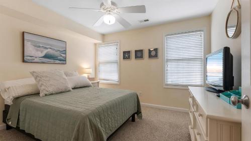 a bedroom with a bed and a flat screen tv at 509 E 15Th Ave, Unit F in North Wildwood