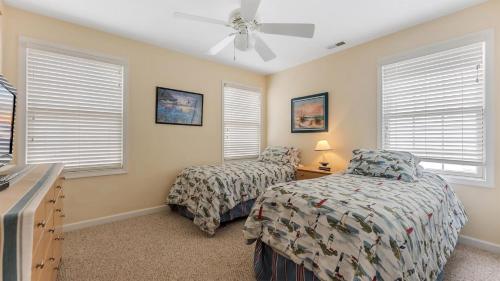 a bedroom with two beds and a ceiling fan at 509 E 15Th Ave, Unit F in North Wildwood