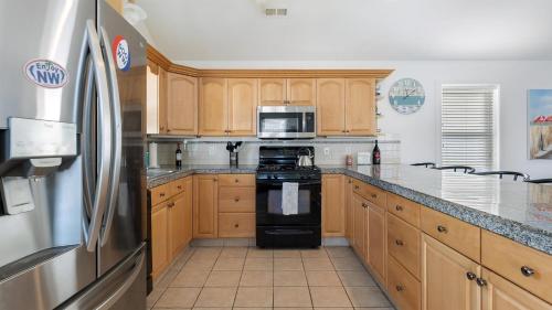 a kitchen with wooden cabinets and a black refrigerator at 414 E 17Th Ave, 2Nd Floor in North Wildwood