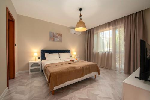 a bedroom with a bed and a tv in it at Messambria Beach Apartments in Sveti Vlas