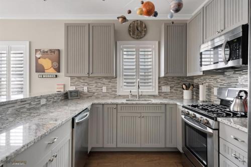 a kitchen with white cabinets and a stove top oven at Residence 104S At The Sandcastle Condominiums in Wildwood Crest
