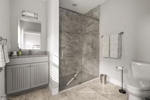 a bathroom with a shower and a toilet and a sink at Residence 104S At The Sandcastle Condominiums in Wildwood Crest