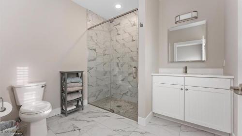 Un baño blanco con inodoro y ducha. en Residence 101S At The Sandcastle Condominiums, en Wildwood Crest