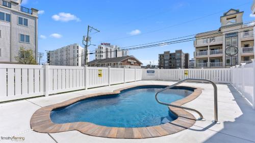 a small swimming pool with a wooden path around it at Residence 104S At The Sandcastle Condominiums in Wildwood Crest