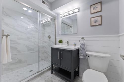 a bathroom with a shower and a toilet and a sink at 1811 Atlantic Ave, Unit 2 in Wildwood